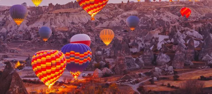Hot air balloons soaring over the unique rock formations of Cappadocia