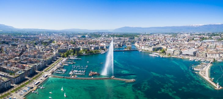 Jet d’Eau fountain and Lake Geneva with city skyline