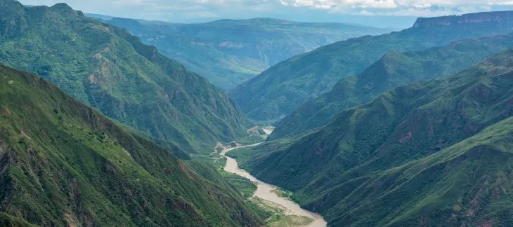 Emerald waters surrounded by lush cliffs at Green Canyon