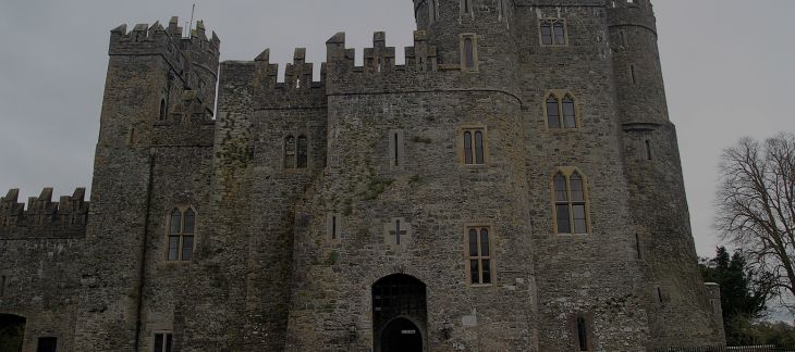 Medieval Hever Castle with surrounding moat and manicured gardens
