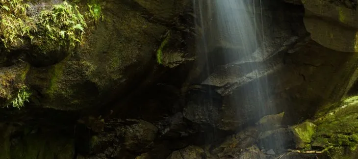 Scenic view of Kravice Falls cascading into emerald pools surrounded by greenery