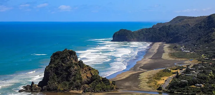 Piha Beach with black sand and rugged coastline on New Zealand's west coast