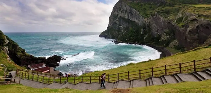 Volcanic crater of Seongsan Ilchulbong rising above Jeju Island’s eastern coast