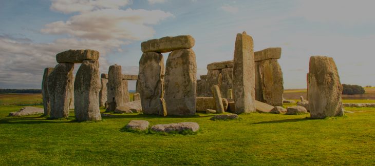 Ancient Stonehenge stone circle silhouetted against the sunset
