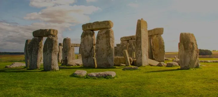 Ancient Stonehenge stone circle silhouetted against the sunset