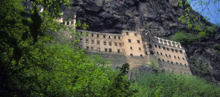 Cliffside Sumela Monastery nestled in lush greenery