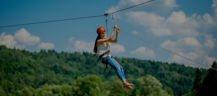 Adventurer soaring on a high-speed zip line at Zip World, Wales