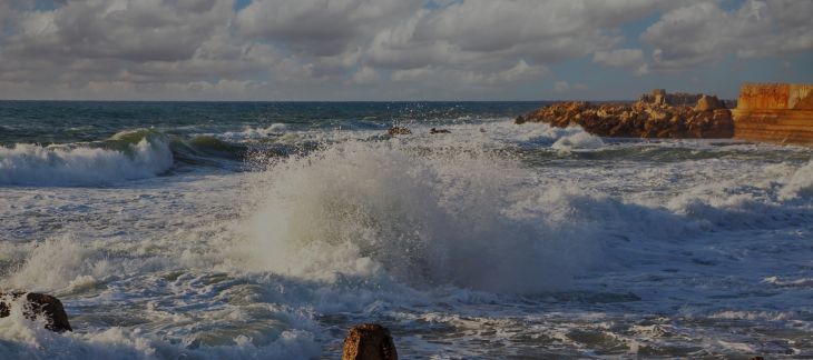Surfers riding waves at Fistral Beach in Newquay, Cornwall