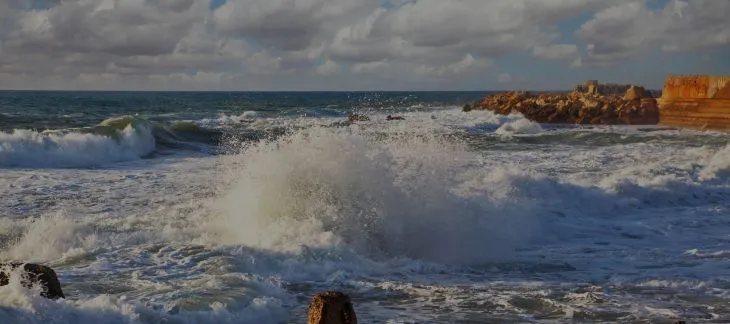 Surfers riding waves at Fistral Beach in Newquay, Cornwall