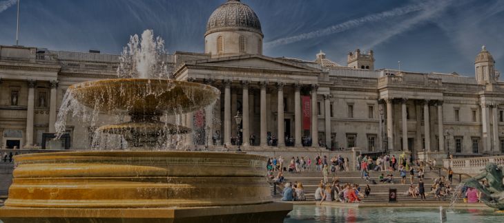 Nelson’s Column at Trafalgar Square surrounded by tourists and fountains