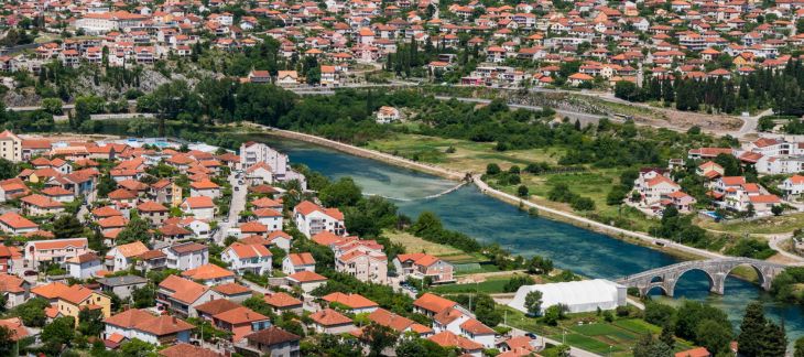 Old town square with stone buildings and river views in Trebinje