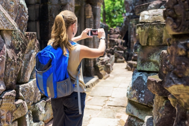Arooha guest tourist photographing in the temple. Angkor, Cambodia
