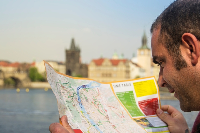 Arooha guest in Prague checking map during Prague tour packages from Dubai