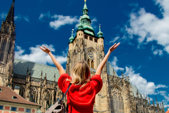Arooha guest in red dress travelling in Prague
