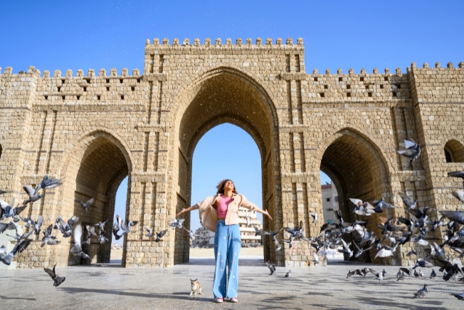 Arooha guest tourist with arms outstretched at Baab Makkah Jeddah