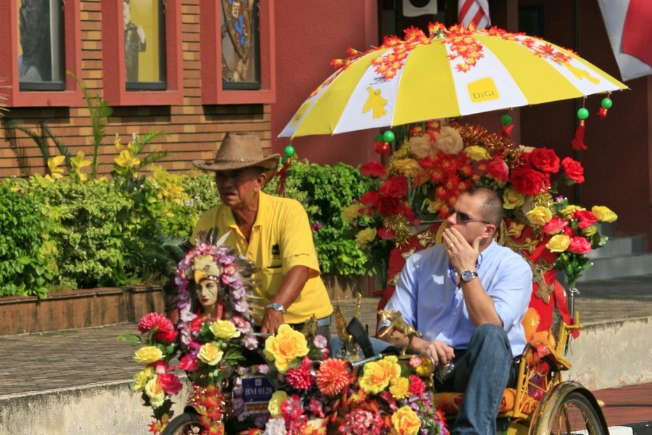 Arooha guest taking colorful rickshaw ride in Malacca, Malaysia