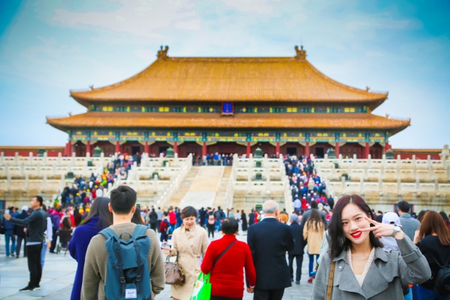 Arooha guest posing at forbidden temple during China tour packages from Dubai