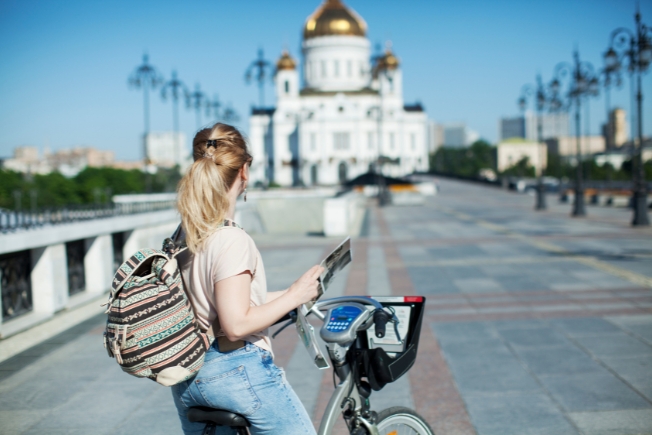 Arooha guest riding bicycle during Russia tour packages from Dubai