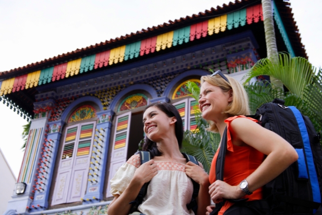 Arooha guest smiling with backpack in Singapore