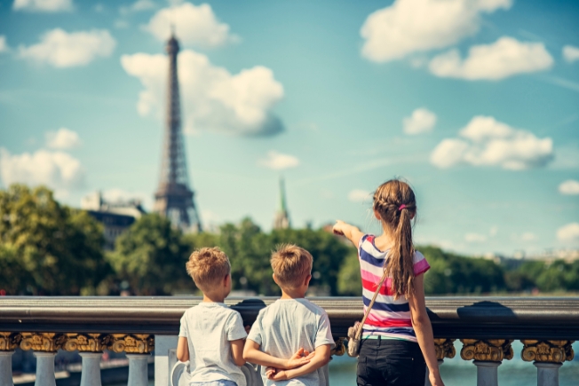 Arooha guest three kids visiting Paris in France looking from Pont Alexandre III