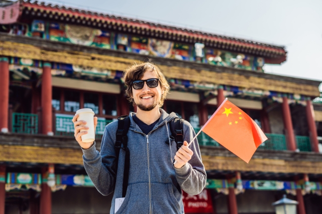 Arooha guest tourist enjoying coffee during China tour packages from Dubai