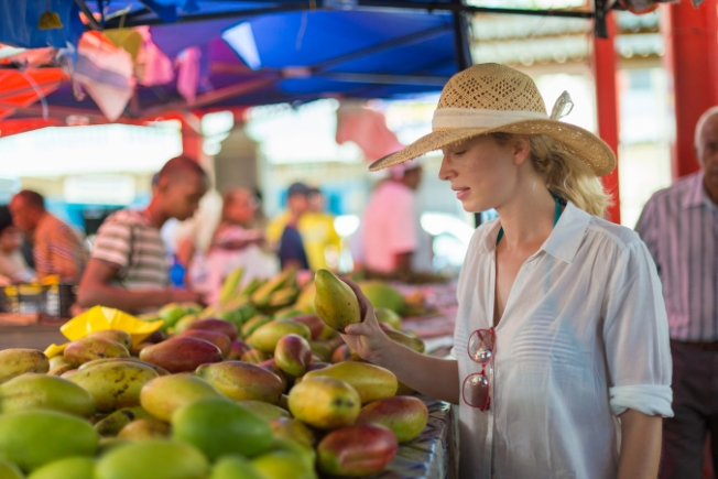 Arooha guest traveler shopping on traditional Victoria food market at Seychelles
