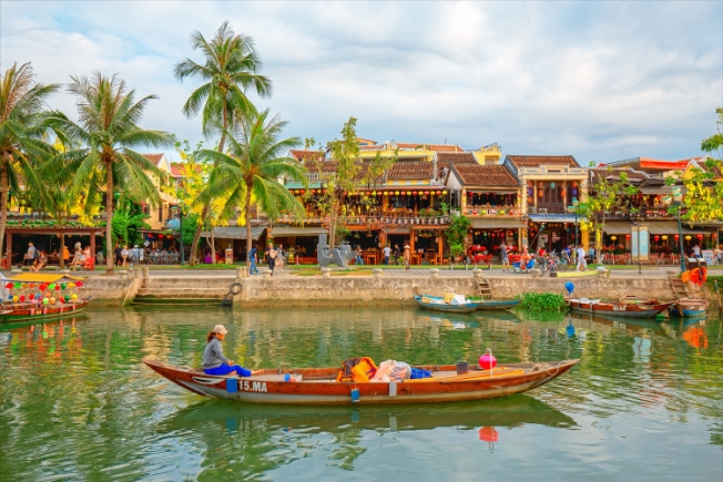 Arooha guest tourist enjoying boat in Hoi An Vietnam