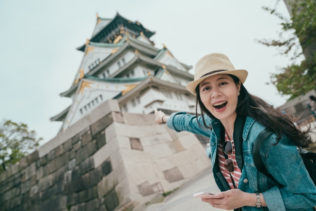 Arooha guest visiting Osaka Castle during Japan tour packages from Dubai