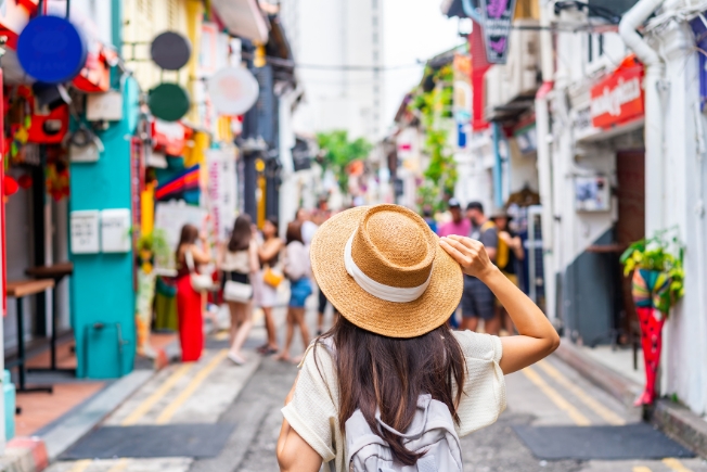 Arooha tourist with backpack walking at Haji Lane in Singapore
