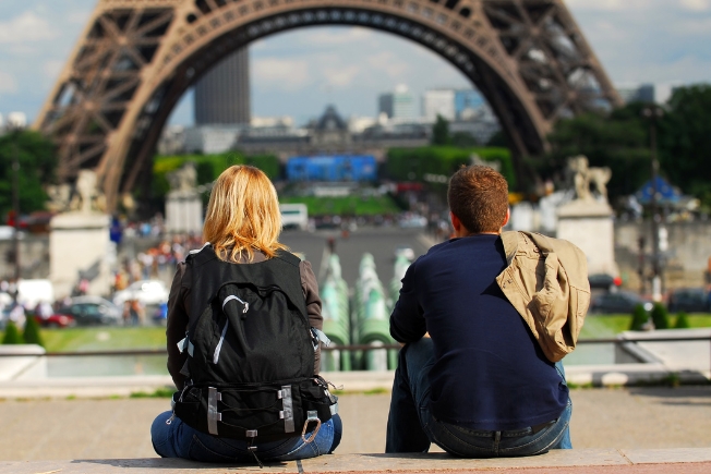 Arooha young tourist couple sitting in front of Eiffel tower at Paris in France