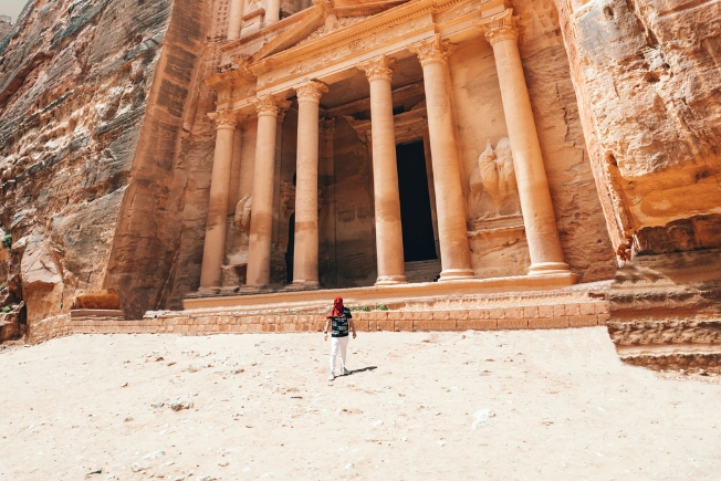 Aroohas guest at ancient temple in old city with tall sandstone columns