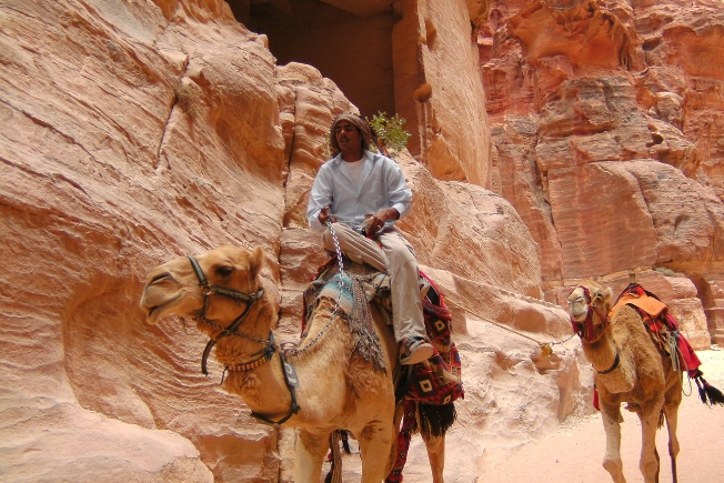 Aroohas guest riding camel in Jordan
